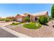 Inviting single-Gathering home with landscaped front yard, synthetic grass, and stone features at 15073 W Piccadilly Rd, Goodyear, AZ 85395
