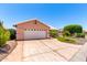 Attractive single-story home featuring a well-kept front yard with vibrant landscaping at 15073 W Piccadilly Rd, Goodyear, AZ 85395