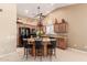 Traditional kitchen features black appliances, granite countertops, and a convenient center island with bar seating at 15073 W Piccadilly Rd, Goodyear, AZ 85395