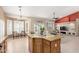 Open floor plan displays the kitchen island blending into the spacious living area, filled with natural light at 15073 W Piccadilly Rd, Goodyear, AZ 85395
