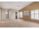 Spacious main bedroom boasts neutral carpet, plantation shutters, and ensuite access at 15073 W Piccadilly Rd, Goodyear, AZ 85395