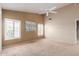 Bright main bedroom features plantation shutters and neutral tones, offering a serene and inviting space at 15073 W Piccadilly Rd, Goodyear, AZ 85395