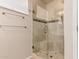 Bathroom shower with frameless glass door and tiled walls, providing a clean and modern look at 15073 W Piccadilly Rd, Goodyear, AZ 85395