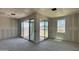 Unfinished living room with sliding glass doors and a window at 15789 W Beryl Ave, Waddell, AZ 85355
