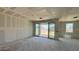 Unfinished living room features sliding glass doors at 15789 W Beryl Ave, Waddell, AZ 85355