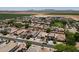Extensive aerial view showing houses in a residential area with desert landscaping and solar panels on the roofs at 1623 E Maplewood Ave, Buckeye, AZ 85326