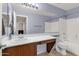 Well-lit bathroom features a spacious vanity, large mirror, and shower-tub combination at 1623 E Maplewood Ave, Buckeye, AZ 85326