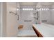 Updated bathroom with a walk-in shower, safety bars, and a built-in bench at 1623 E Maplewood Ave, Buckeye, AZ 85326