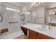 Bright bathroom with marble-look walk-in shower, sink, and fixtures designed for accessibility and style at 1623 E Maplewood Ave, Buckeye, AZ 85326