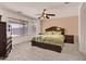 Cozy bedroom featuring a large bed, plush carpet, and a ceiling fan at 1623 E Maplewood Ave, Buckeye, AZ 85326