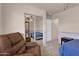 Comfortable bedroom includes recliner, mirrored closet, and light fixtures at 1623 E Maplewood Ave, Buckeye, AZ 85326