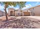 Charming single-story home featuring a low-maintenance desert landscape and a two-car garage at 1623 E Maplewood Ave, Buckeye, AZ 85326