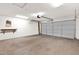 Spacious two-car garage features a pull-down door and concrete flooring at 1623 E Maplewood Ave, Buckeye, AZ 85326