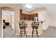 Kitchen bar area features countertop seating, providing a casual dining space and seamless transition to the adjacent room at 1623 E Maplewood Ave, Buckeye, AZ 85326