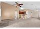 Open-concept living room with carpet and an eat-in kitchen with barstool seating at 1623 E Maplewood Ave, Buckeye, AZ 85326