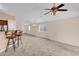 Bright living room showcasing carpeted floors and an open layout, complemented by ample natural light and neutral tones at 1623 E Maplewood Ave, Buckeye, AZ 85326