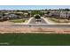 Scenic street view in a residential neighborhood, with well-kept lawns, desert landscaping and block wall fences at 1623 E Maplewood Ave, Buckeye, AZ 85326