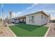 Beautiful backyard features a covered patio, artificial grass, and neutral colored exterior at 16342 W Jackson St, Goodyear, AZ 85338