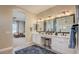Bathroom featuring a double vanity, makeup station, and a walk-in shower at 16342 W Jackson St, Goodyear, AZ 85338