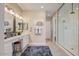 Elegant bathroom with double vanity, decorative mirrors, and a glass shower at 16342 W Jackson St, Goodyear, AZ 85338