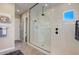Modern walk-in shower boasting black fixtures and white subway tile at 16342 W Jackson St, Goodyear, AZ 85338