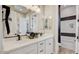 A modern bathroom features a double vanity, a decorative mirror, and a shower at 16342 W Jackson St, Goodyear, AZ 85338