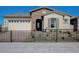 Charming single-story home with stone accents, desert landscaping, and secure black metal fence at 16342 W Jackson St, Goodyear, AZ 85338