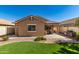 Beautiful backyard with turf, decorative rock, and outdoor cooking area at 1688 W Corriente Dr, San Tan Valley, AZ 85144