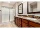 Bathroom with dual vanity, stone counters, and glass shower enclosure at 1688 W Corriente Dr, San Tan Valley, AZ 85144