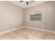 Neutral-toned bedroom with ceiling fan, tile flooring, and bright window at 1688 W Corriente Dr, San Tan Valley, AZ 85144