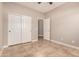 Neutral-toned bedroom with ceiling fan, tile flooring, closet, and white doors at 1688 W Corriente Dr, San Tan Valley, AZ 85144