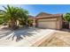 Charming home features a spacious driveway, mature landscaping, and a two-car garage at 1688 W Corriente Dr, San Tan Valley, AZ 85144