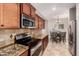 Gourmet kitchen featuring stainless appliances, granite counters, and breakfast nook at 1688 W Corriente Dr, San Tan Valley, AZ 85144