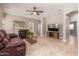 Inviting living room with tile floors and a cozy media cabinet at 1688 W Corriente Dr, San Tan Valley, AZ 85144