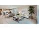 Open-concept living room featuring tile flooring, neutral paint, lots of natural light and an open kitchen at 17387 W Whispering Wind Rd, Surprise, AZ 85387