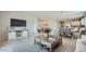 Spacious living room featuring recessed lighting, tile flooring, neutral paint, and an open floor plan at 17387 W Whispering Wind Rd, Surprise, AZ 85387