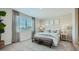 Cozy main bedroom with neutral decor, carpet, and a large window at 17387 W Whispering Wind Rd, Surprise, AZ 85387