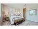 Cozy main bedroom with neutral decor, carpet, and a connecting bathroom at 17387 W Whispering Wind Rd, Surprise, AZ 85387
