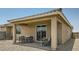 Cozy covered patio with comfortable seating and an outdoor dining area, perfect for entertaining or relaxing at 17387 W Whispering Wind Rd, Surprise, AZ 85387