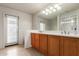 Bathroom has a dual vanity, a large mirror, and a glass-enclosed shower at 1851 W Vermont Ave, Phoenix, AZ 85015