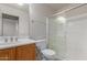 Bathroom has a single vanity, a mirror, toilet, and a glass-enclosed shower at 1851 W Vermont Ave, Phoenix, AZ 85015