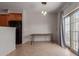 Open dining area with wood table, tile floors, neutral walls and glass door to a patio at 1851 W Vermont Ave, Phoenix, AZ 85015