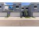 Contemporary townhome with private garage and balcony with modern gray stucco and a well-manicured landscape at 1851 W Vermont Ave, Phoenix, AZ 85015
