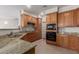 Kitchen featuring granite countertops, wooden cabinets and black appliances at 1851 W Vermont Ave, Phoenix, AZ 85015