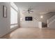 Bright living room featuring tile floors, neutral paint, and staircase, creating a welcoming atmosphere at 1851 W Vermont Ave, Phoenix, AZ 85015