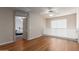 Open loft area featuring laminate floors, a ceiling fan, and a window with a slatted shade at 1851 W Vermont Ave, Phoenix, AZ 85015