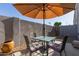 Cozy patio features an umbrella, table, and chairs at 1851 W Vermont Ave, Phoenix, AZ 85015