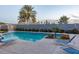 Inviting community pool featuring lounge chairs, lush landscaping, and well-maintained grounds at 1851 W Vermont Ave, Phoenix, AZ 85015