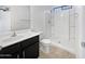 A bright bathroom with a walk-in shower, white toilet and black vanity at 1953 W Stage Driver St, Apache Junction, AZ 85120