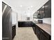 Well-lit kitchen with stainless steel appliances, black cabinetry, and direct view to dining area at 1953 W Stage Driver St, Apache Junction, AZ 85120